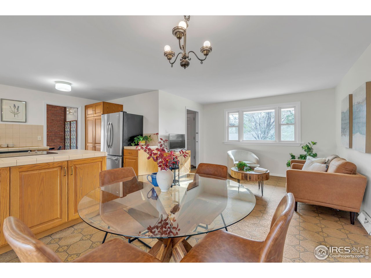 2425 Vassar Drive Boulder, CO 80305 - Photo 11 of 30 a living room with furniture a chandelier and a dining table