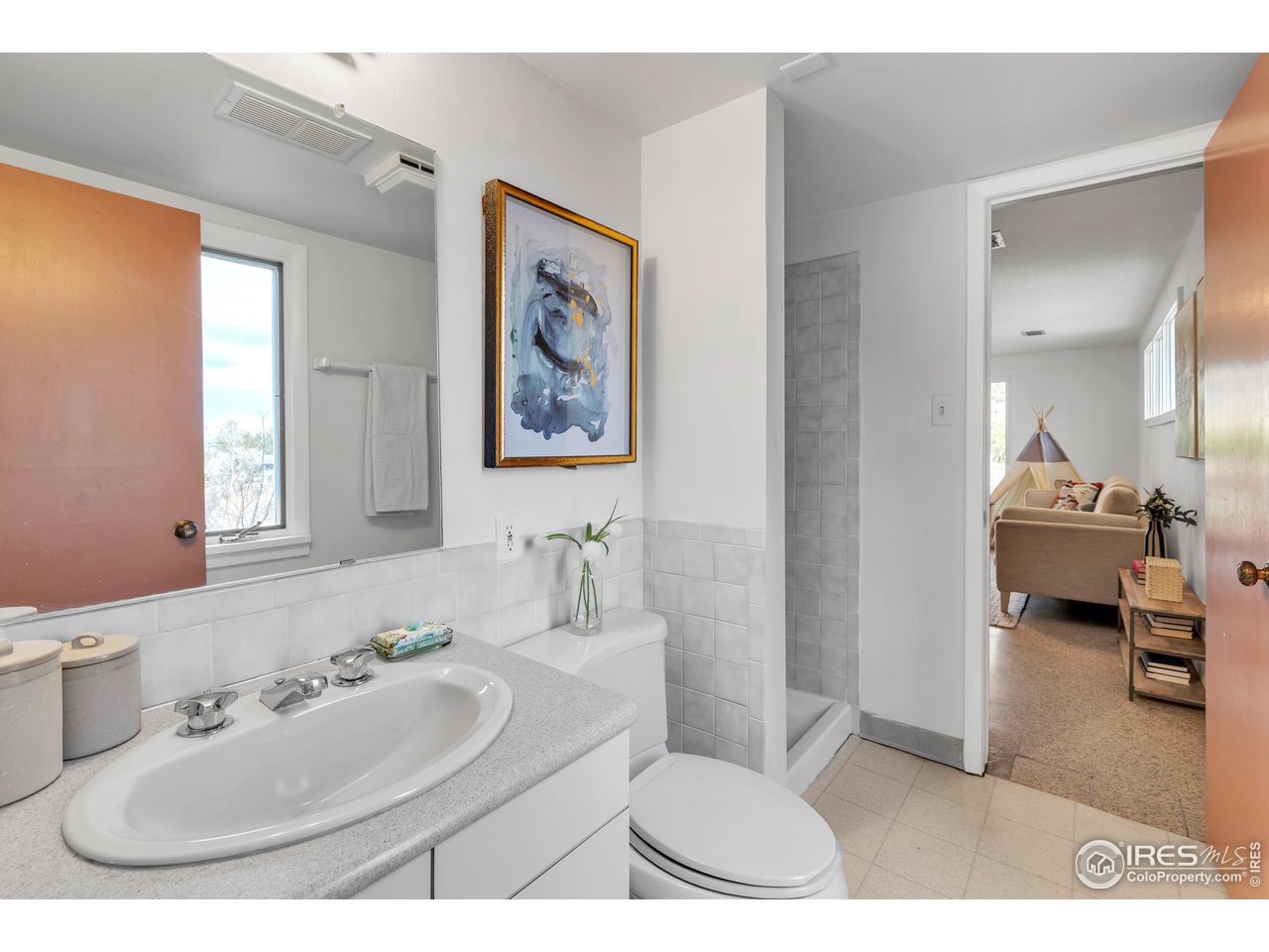 2425 Vassar Drive Boulder, CO 80305 - Photo 19 of 30 a bathroom with a toilet sink and mirror