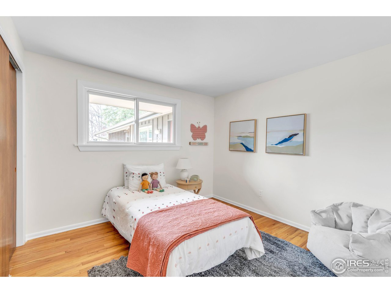 2425 Vassar Drive Boulder, CO 80305 - Photo 22 of 30 a bedroom with a bed and wooden floor