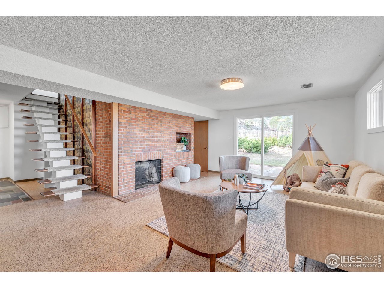 2425 Vassar Drive Boulder, CO 80305 - Photo 24 of 30 a living room with fireplace furniture and a large window
