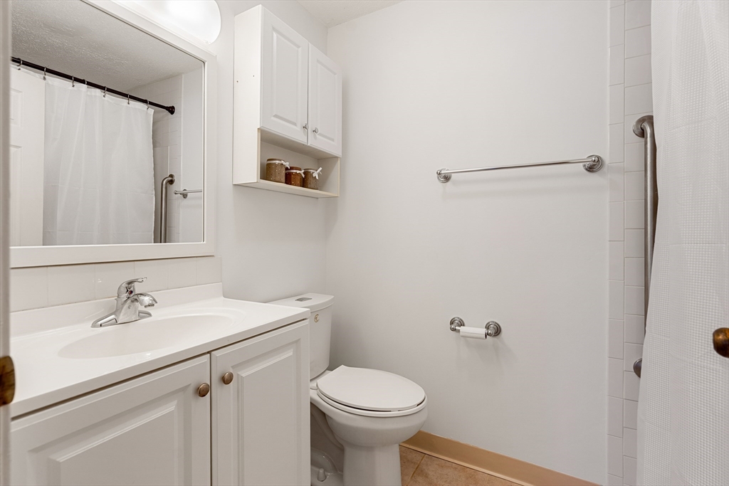 181 Littleton Road, Unit 134 Chelmsford, MA 01824 - Photo 11 of 20 a bathroom with a sink toilet and a mirror