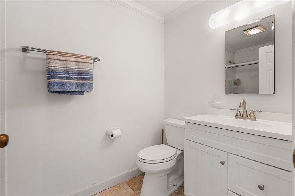 181 Littleton Road, Unit 134 Chelmsford, MA 01824 - Photo 14 of 20 a bathroom with a toilet a sink a vanity and mirror