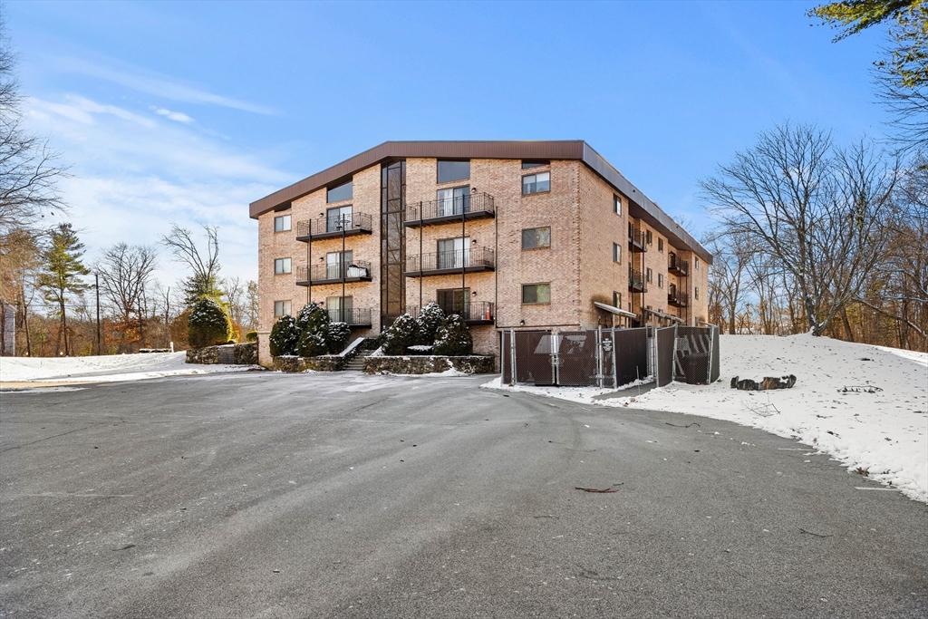 181 Littleton Road, Unit 134 Chelmsford, MA 01824 - Photo 20 of 20 a view of a building with a snow on the road