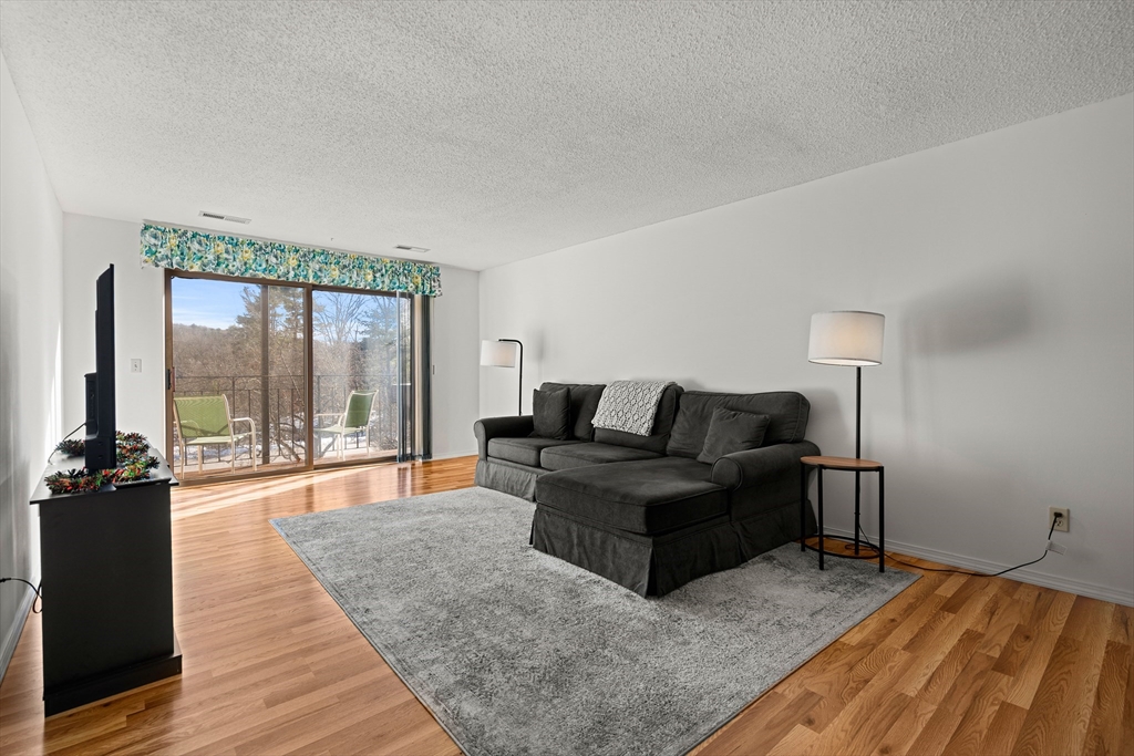 181 Littleton Road, Unit 134 Chelmsford, MA 01824 - Photo 2 of 20 a living room with furniture and a large window