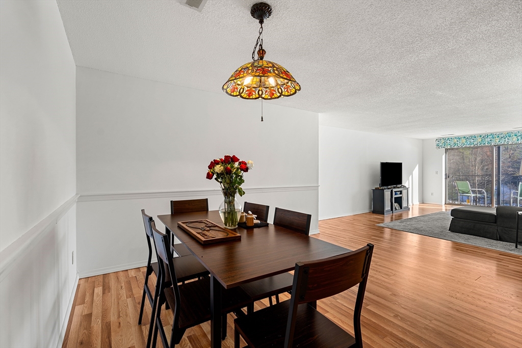 181 Littleton Road, Unit 134 Chelmsford, MA 01824 - Photo 5 of 20 a dining room with furniture and wooden floor