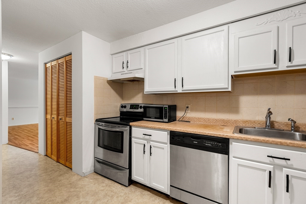 181 Littleton Road, Unit 134 Chelmsford, MA 01824 - Photo 8 of 20 a kitchen with stainless steel appliances granite countertop white cabinets a sink and dishwasher