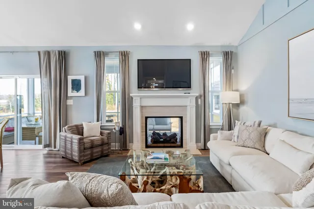 a living room with furniture fireplace and flat screen tv