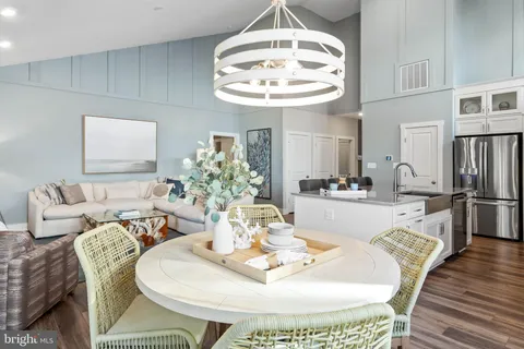 a bedroom with a bed potted plant on dresser and a window