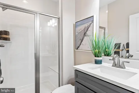 a view of a patio with dining table and chairs with wooden floor and fence