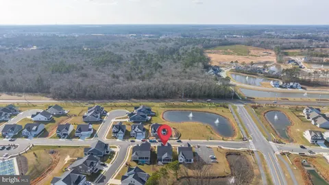 a view of swimming pool with seating area and trees in the background