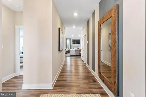 a bedroom with a couch and wooden floor