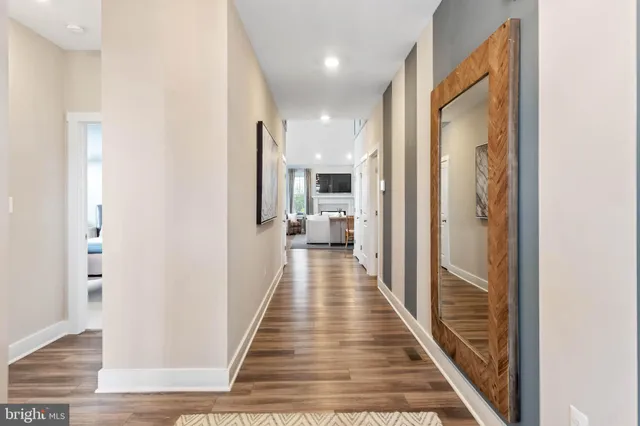 a bedroom with a couch and wooden floor