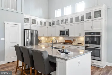 a kitchen with stainless steel appliances granite countertop a stove and cabinets