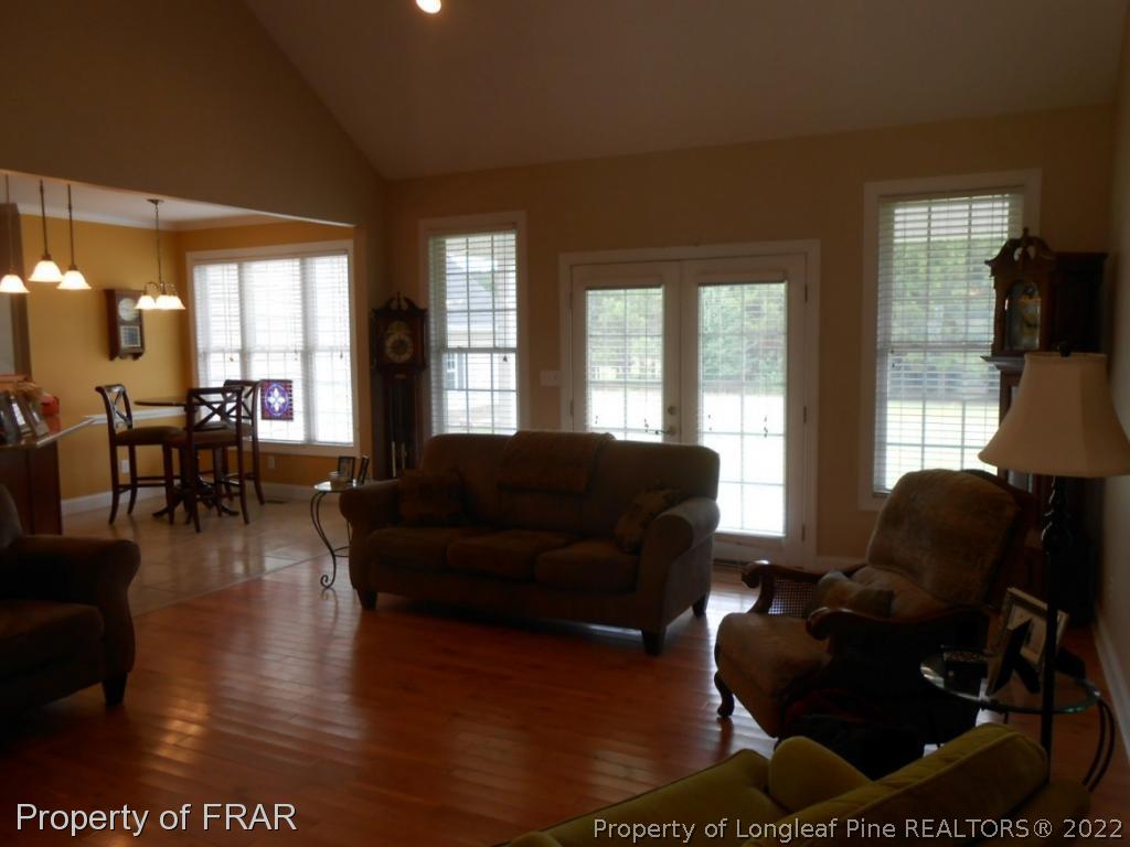 6257 Howell Road Lumberton, NC 28358 - Photo 13 of 34 a living room with furniture wooden floor and floor to ceiling windows