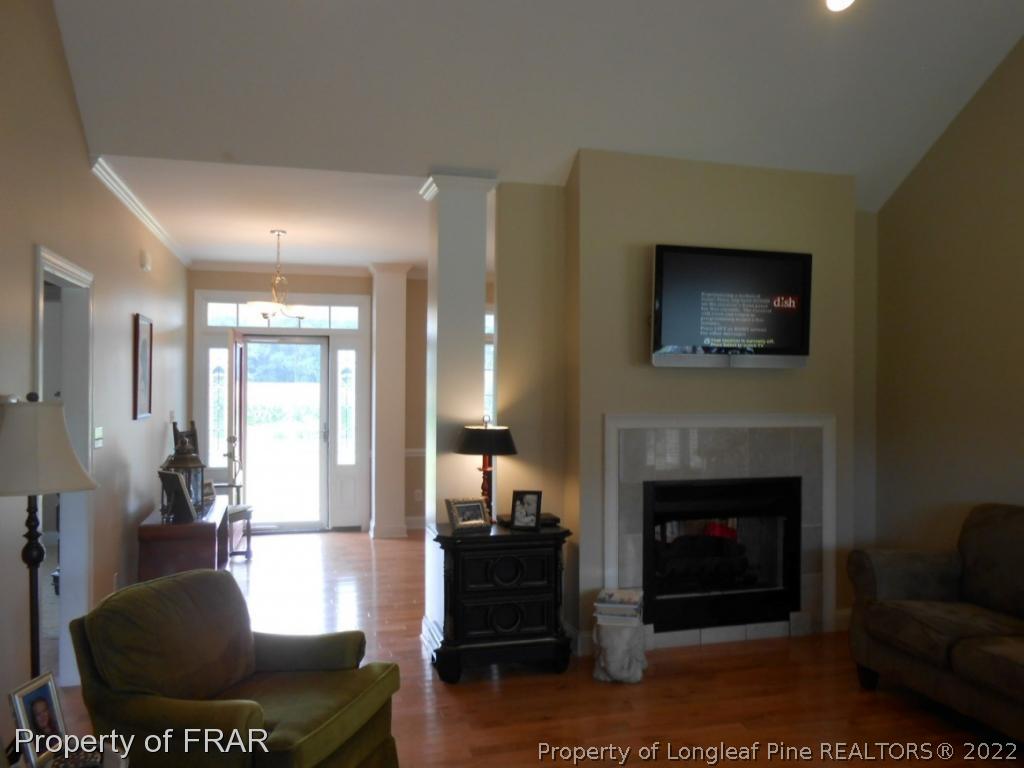 6257 Howell Road Lumberton, NC 28358 - Photo 14 of 34 a living room with furniture a fireplace and a flat screen tv