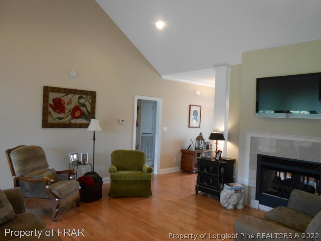 6257 Howell Road Lumberton, NC 28358 - Photo 16 of 34 a living room with furniture a flat screen tv and a fireplace