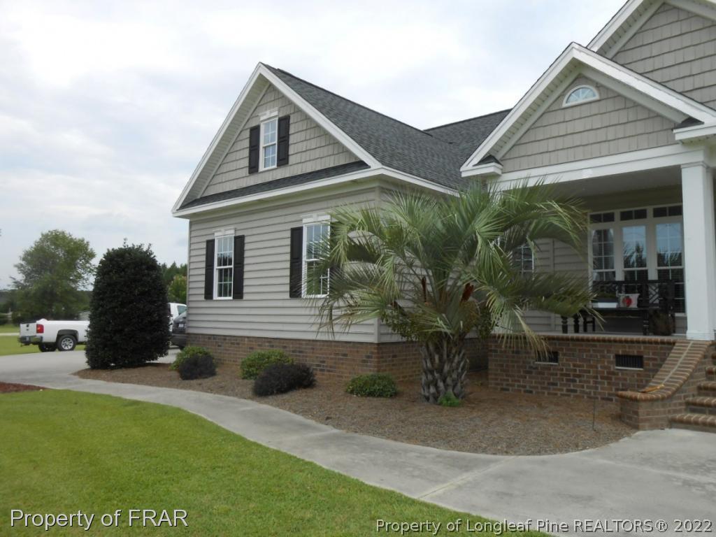 6257 Howell Road Lumberton, NC 28358 - Photo 2 of 34 a front view of a house with garden
