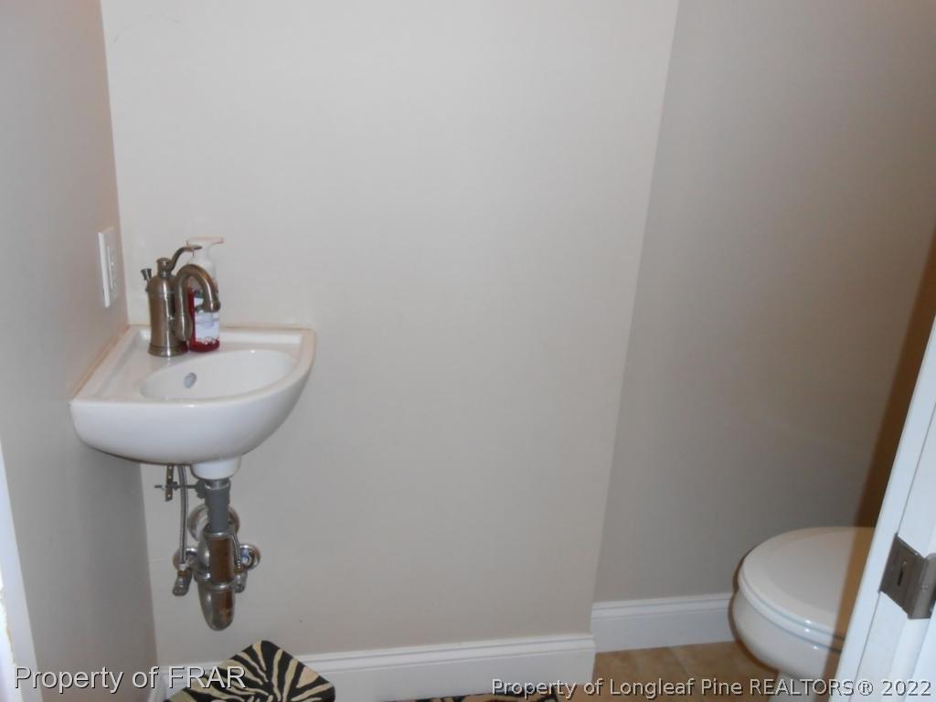6257 Howell Road Lumberton, NC 28358 - Photo 25 of 34 a bathroom with a sink a toilet and mirror