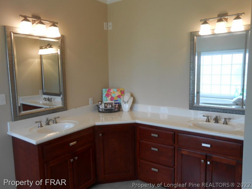 6257 Howell Road Lumberton, NC 28358 - Photo 29 of 34 a bathroom with a sink vanity and mirror