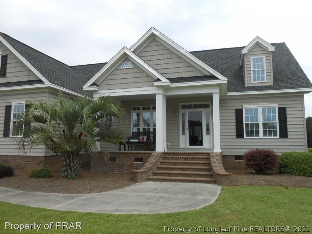 6257 Howell Road Lumberton, NC 28358 - Photo 3 of 34 a front view of a house with garden