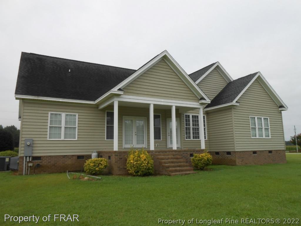 6257 Howell Road Lumberton, NC 28358 - Photo 6 of 34 a front view of a house with a garden