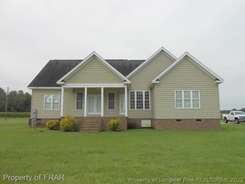 6257 Howell Road Lumberton, NC 28358 - Photo 7 of 34 a front view of a house with a garden