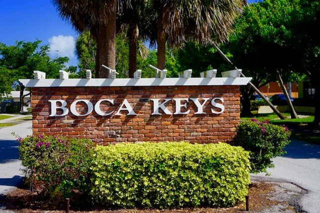 a front view of a house with plants and entryway