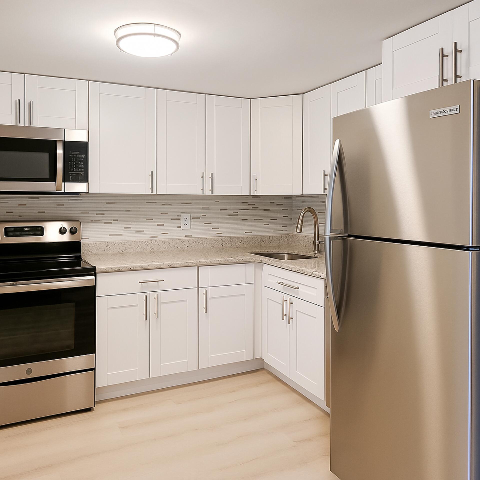 665 Glouchester Street, Unit 6 Boca Raton, FL 33487 - Photo 16 of 16 a kitchen with stainless steel appliances granite countertop a refrigerator a stove a microwave and cabinets