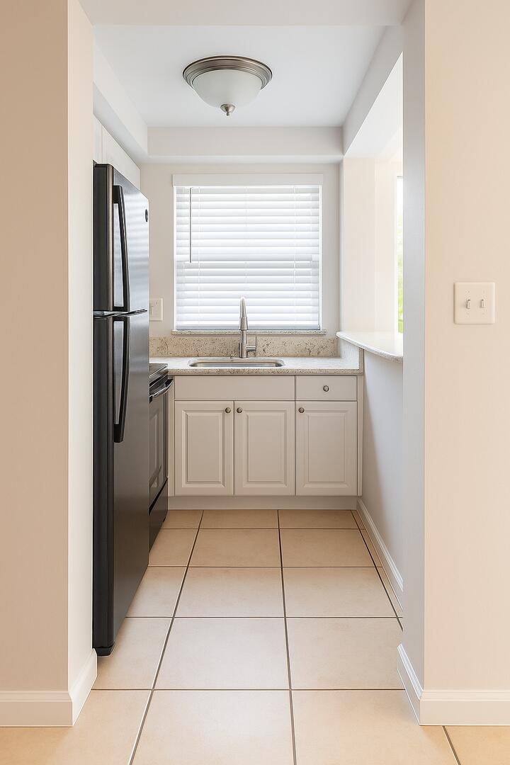 665 Glouchester Street, Unit 6 Boca Raton, FL 33487 - Photo 2 of 16 a kitchen with stainless steel appliances granite countertop a refrigerator and a sink