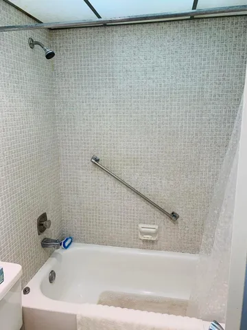 a bathroom with a bathtub and a shower