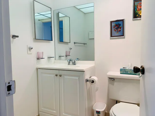 a bathroom with a toilet sink and mirror