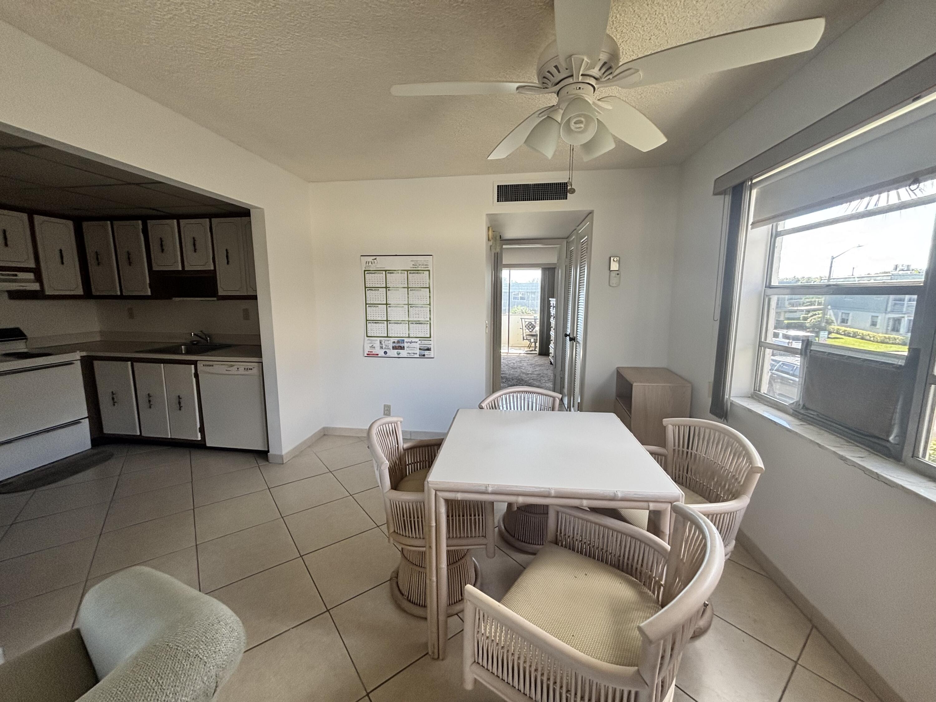 514 Flanders K Delray Beach, FL 33484 - Photo 9 of 10 a dining room with furniture and window