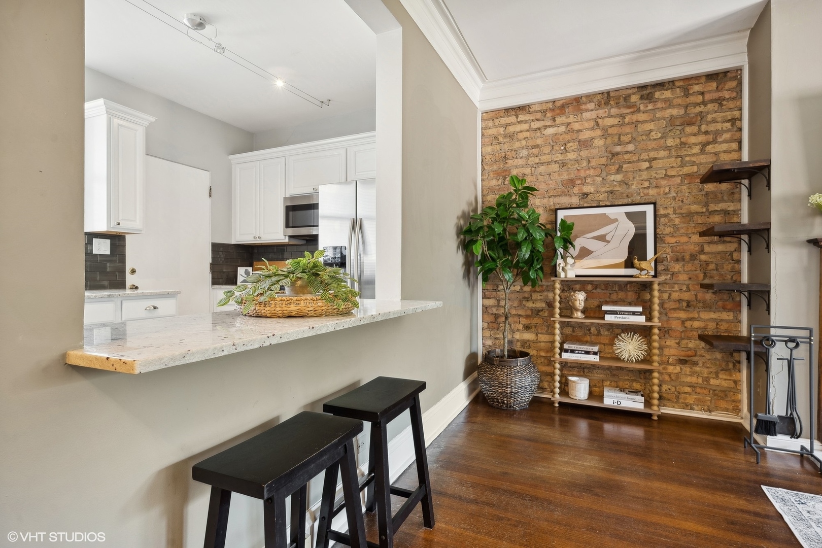 3749 North Pine Grove Avenue, Unit 3 Chicago, IL 60613 - Photo 3 of 18 a view of a dining room with furniture wooden floor and kitchen view