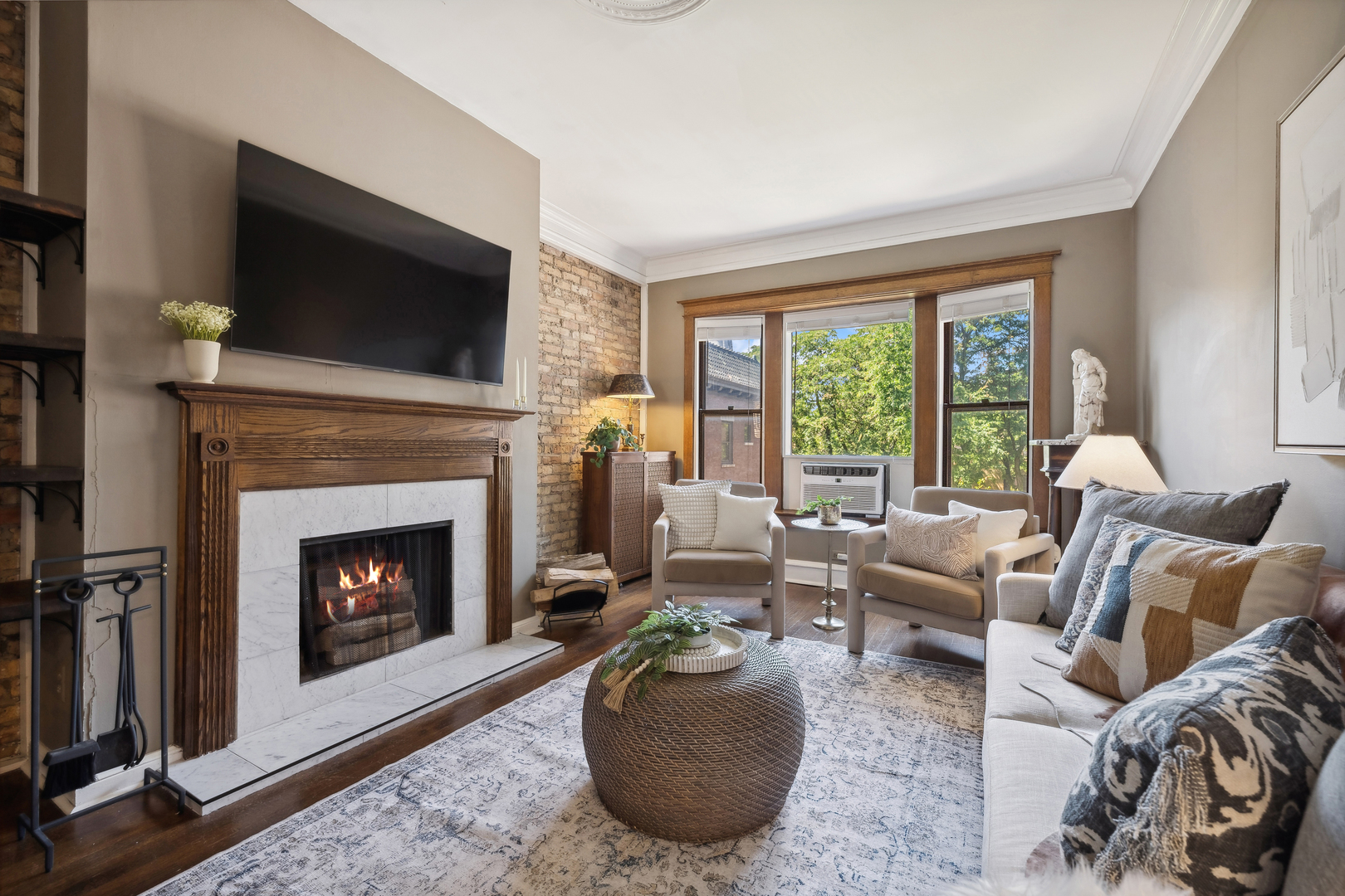 3749 North Pine Grove Avenue, Unit 3 Chicago, IL 60613 - Photo 5 of 18 a living room with furniture a flat screen tv and a fireplace