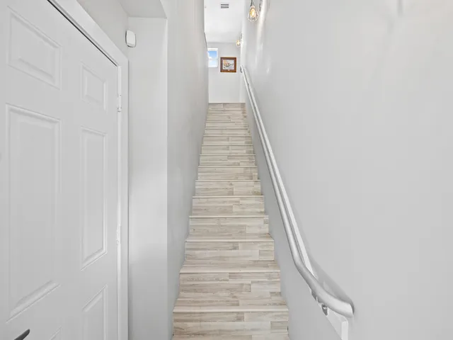 a view of a hallway with stairs
