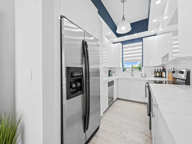 a kitchen with a refrigerator and a sink