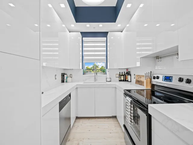 a kitchen with a sink stove and cabinets