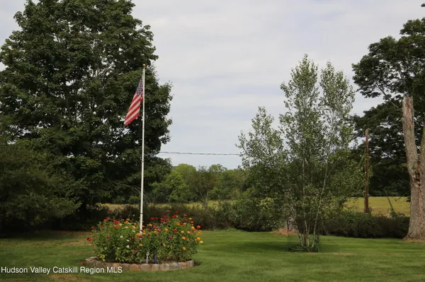 a garden with trees in front of it