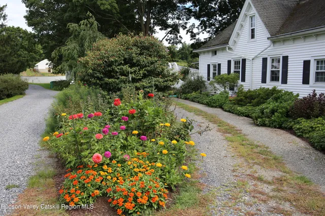a front view of a house with a yard and fountain