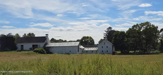 a view of a house with a yard and sitting area
