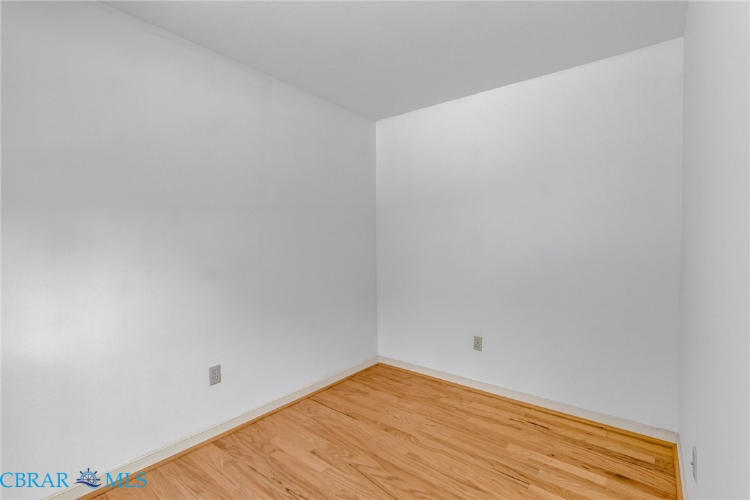 278 Regent Road Hartfield, VA 23071 - Photo 24 of 49 Empty room with wood finished floors and baseboards