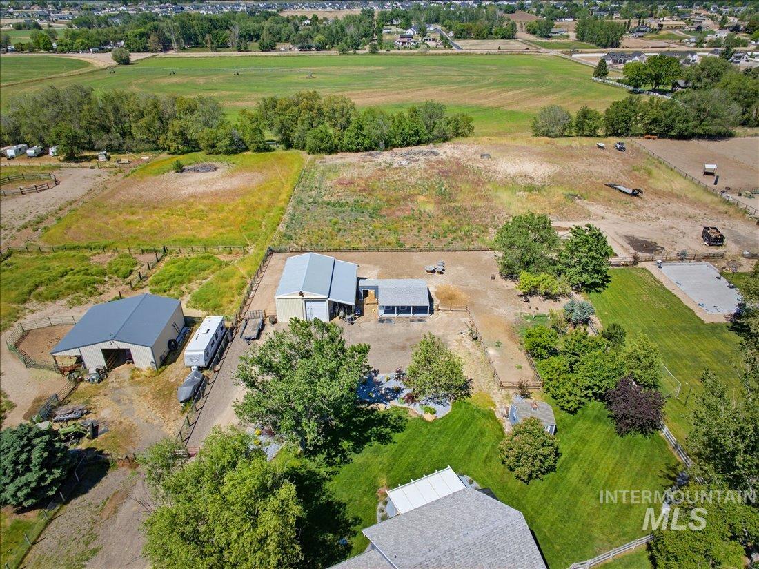 24623 Falcon Lane Caldwell, ID 83607 - Photo 39 of 40 Aerial perspective showcasing a property with multiple outbuildings, fenced areas, and surrounding fields