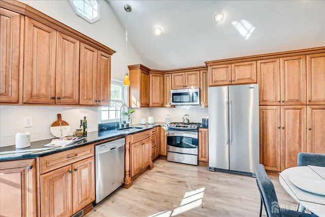 a spacious bathroom with a double vanity sink toilet mirror and shower