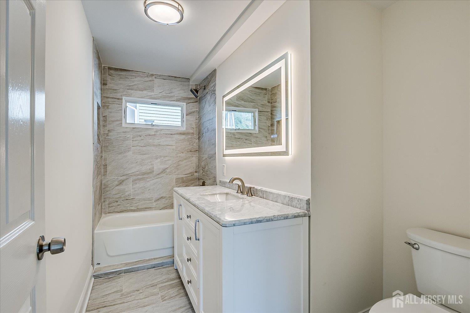 341 Victor Place Neptune, NJ 07753 - Photo 29 of 45 a bathroom with a granite countertop sink toilet and shower