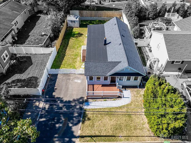an aerial view of a house with a yard and swimming pool