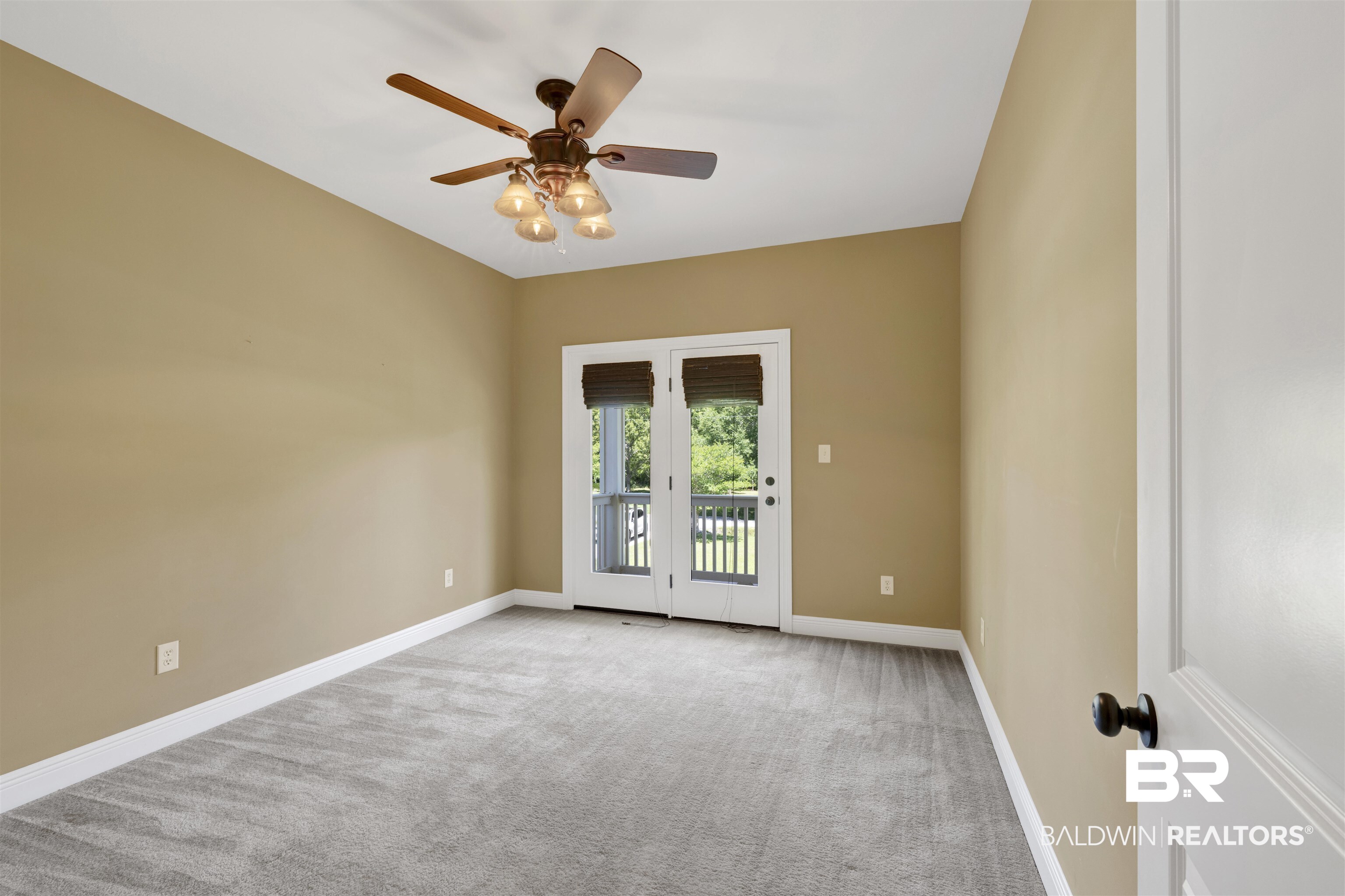 12944 Anna's Way Stapleton, AL 36578 - Photo 56 of 64 Expansive room featuring plush grey carpeting, neutral wall finishes, and a ceiling fan with integrated lighting