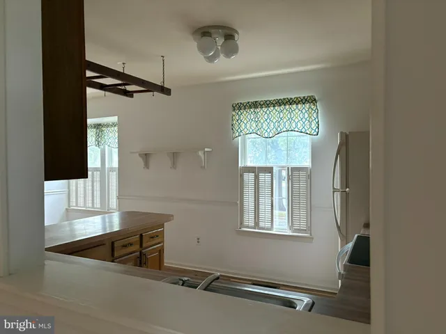 a view of walk in closet with wooden floor and door