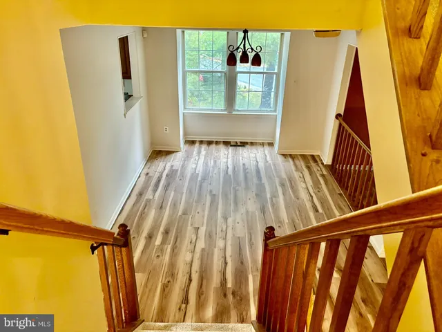 a view of a room with wooden floor and fan