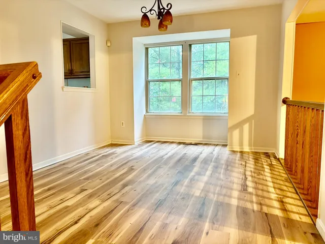 a view of a room with wooden floor and bathroom