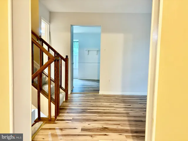 view of a kitchen with refrigerator and wooden floor